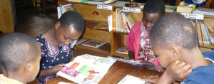 Children reading books at table
